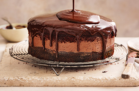With light sponges, silky milk chocolate buttercream and glossy dark chocolate ganache, this decadent cake recipe is a chocolate lover's dream