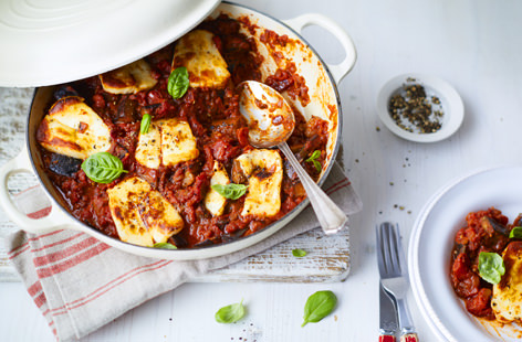 Plump aubergine is cooked slowly in a rich pesto, paprika and cumin-spiced tomato sauce, until satisfyingly soft and tender – it's then topped with creamy halloumi and baked until gooey and golden