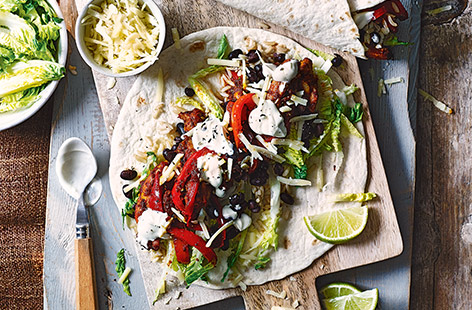 Craving a takeaway? Try this quick and super simple chicken burrito 'fakeaway' for two. The spicy Mexican chicken and pepper filling is ready in just 20 minutes, then you can build your own tortilla wraps.