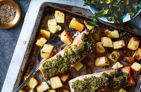 Spicy kale pesto gives this easy salmon traybake recipe a real lift, perfect for a midweek dinner.