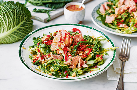 Celebrate the distinctive sweet, earthy flavour of savoy cabbage in this light lunchtime salad. Cooking the salmon in a foil parcel with chilli and lime seals in all the flavours – be generous with the coconut dressing too!
