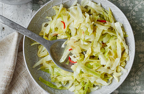 This vegetarian side dish will add a touch of heat to your Sunday roast - thinly sliced red chilli and garlic are finely sliced and stir-fried with the cabbage for tender aromatic results.