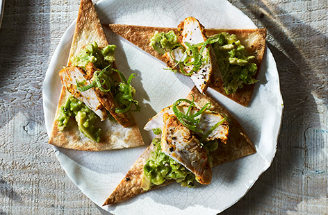 Baked tortilla wrap triangles topped with ready-prepared chicken make a tasty dairy-free canapé recipe that’s both quick and easy to put together: perfect for a drinks party or as a starter