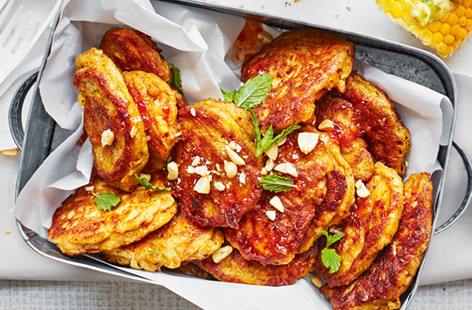 Whip up a batch of these versatile satay fritters for an easy street food-inspired snack or starter. The creamy peanut butter batter holds together carrots, chickpeas and spring onion for healthy finger food.