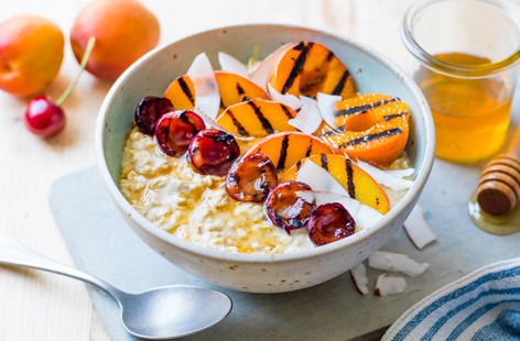 Give your breakfast the special treatment this summer by stirring in delicious griddled fruits into your porridge. Oats soaked overnight in yoghurt and juice don't need cooking: simply add the fresh griddled toppings and finish with coconut flakes and honey for added snazz.