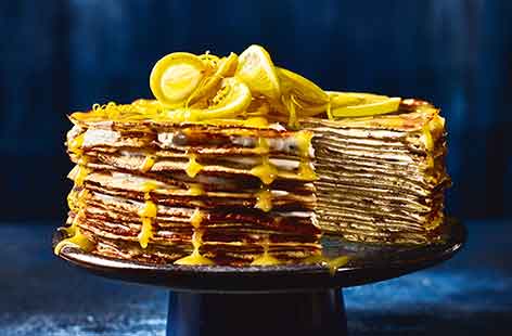 Look no further for a unique, dinner party dessert! This layered crêpe cake stacks lacy pancakes topped with a tangy, lemon curd swirled yoghurt for a striking pudding that easily feeds a crowd
