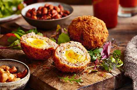 This traditional pub snack has been updated with added bacon and sweet maple syrup for extra indulgence. The Scotch eggs can be served hot or cold and make a delicious lunch served with a light green salad.