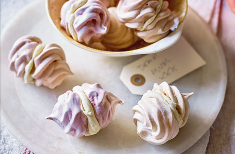 These sweet little pastel-hued meringues are pretty as a picture. The meringue is coloured with pink, orange and purple swirls and filled with a vanilla flavoured frosting. 