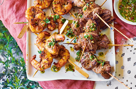 Forget juggling a plate of food with your drink; these fuss-free Spanish kebabs make it easy to munch while mingling. Marinate lamb leg pieces and king prawns ahead of time in a bold smoky spice mix and simply grill or barbecue when your guests arrive.