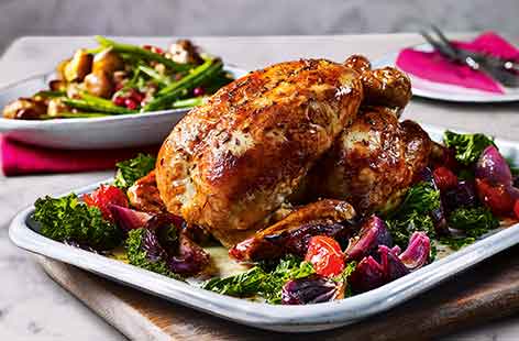 Spice up your Sunday roast with a gloriously fragrant chicken with saffron stuffing. Sticky orange-roasted onions, kale and tomatoes are cooked alongside the chicken for extra chicken, whilst crispy crushed potatoes complete this ultimate Sunday lunch.