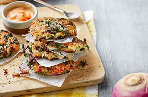 These super crispy rostis make the most of seasonal winter vegetables by pairing turnips, potatoes and kale with plenty of fragrant coriander and a spicy mayonnaise for a tasty vegetarian dinner.