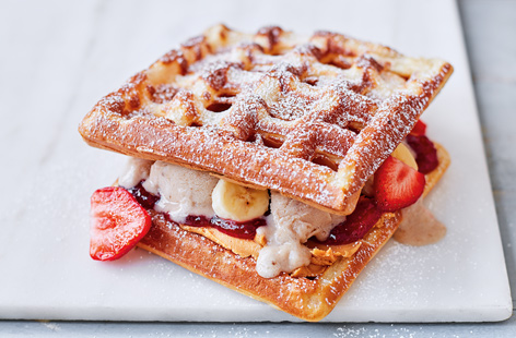 We've taken the American classic, a peanut butter and jam sandwich, up a notch for the ultimate summer treat. Crisp homemade waffles are sandwiched with easy instant homemade banana ice cream, sweet strawberry jam and fresh fruit for an indulgent sweet fix