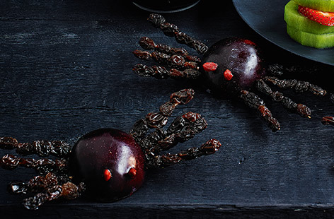 These sweet spiders make a tasty Halloween treat, yet are made completely out of fruit. With a juicy plum body, raisin legs, and scary red berry eyes, this creative recipe is fun to make, too.
