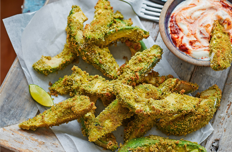 Coated in a fragrant coriander crumb and baked until crisp, these avocado wedges are sure to steal the show at your next brunch. Served with a creamy, fiery chipotle yogurt, healthy snacks don't get much more heavenly than this