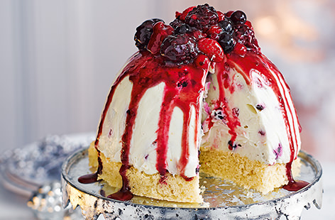 This stunning dessert tastes as heavenly as it looks. A dome of creamy white chocolate mousse sits atop a light sponge base and is topped with an array of summer fruits and a cascading fruit coulis