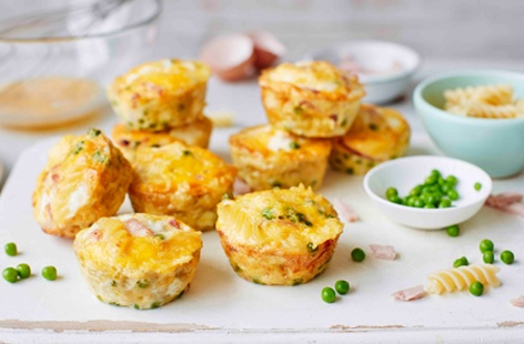Healthy snacks for kids don't get much more satisfying than this! Packed with hearty fusilli pasta, shelled peas, thick-cut ham and fresh eggs these simple baked frittatas are really easy to make and perfect for the kids to enjoy whilst out and about 