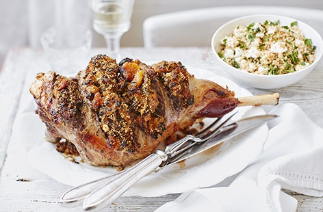 This leg of lamb recipe is made with a fragrant stuffing of sweet apricots, pistachios and za'atar and served with toasted couscous, creamy feta and parsley