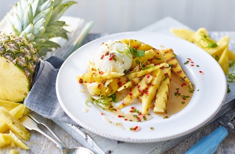Transport your guests to the tropics with this refreshing dessert: sweet pineapple, charred on a griddle pan and drizzled with a gorgeously sticky rum and chilli syrup topped with a dollop of homemade piña colada ice cream