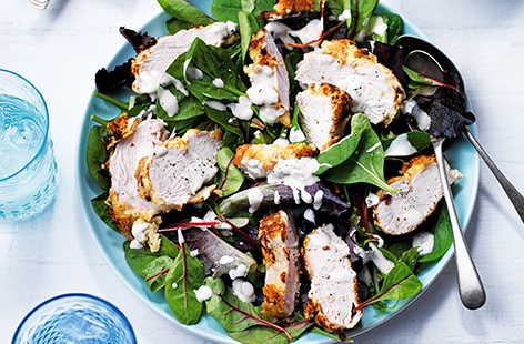 Classic Caesar salad has been given an American makeover with the addition of Southern-fried chicken which is coated in a spiced buttermilk batter before lightly baking. Serving on crisp green leaves with a creamy mayo and white wine vinegar dressing gives