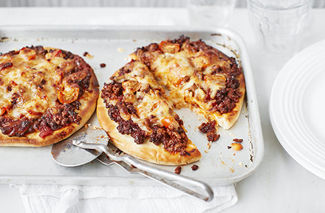 Give your pizzas a Mexican spin with this tasty taco pizza recipe. Kids will love this simple dish, which is made using readymade pizza bases topped with beef, tomato sauce and gooey mozzarella