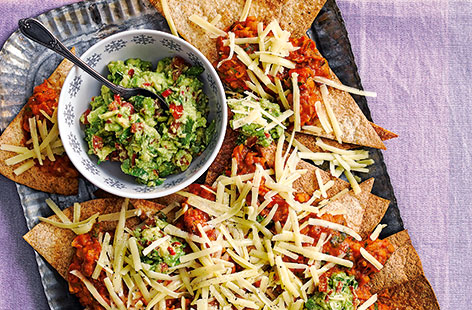 This Mexican-inspired dish is perfect for sharing! With crisp tortillas, spicy mixed beans, homemade avocado salsa and plenty of mature Cheddar, this easy nachos recipe takes just over half an hour to make but is sure to be devoured in minutes