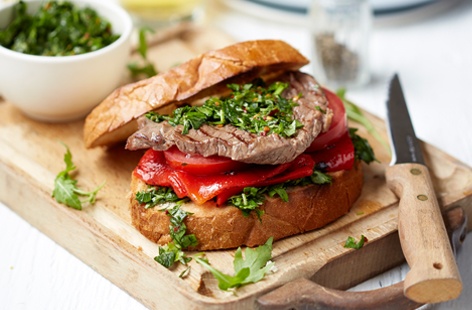 Give a simple weekend steak sandwich an Argentinian spin by adding some spicy chimichurri sauce, juicy roasted peppers and peppery rocket.