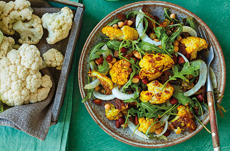 A simple, warm seasonal salad with cumin-roasted cauliflower and almonds, tossed with thinly sliced raw fennel, chickpeas, rocket and sultanas. A tangy yoghurt, lemon juice and garlic dressing is drizzled over the top just before serving.