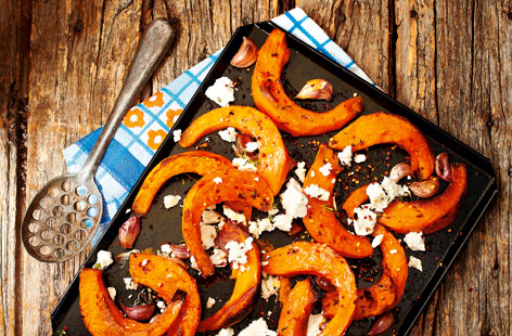 A delicious way of using up squash: roasted sliced pumpkin with tangy feta and aromatic thyme, chilli and garlic. This gloriously autumnal dish works perfectly as a side or as a main course, spooned into wraps.