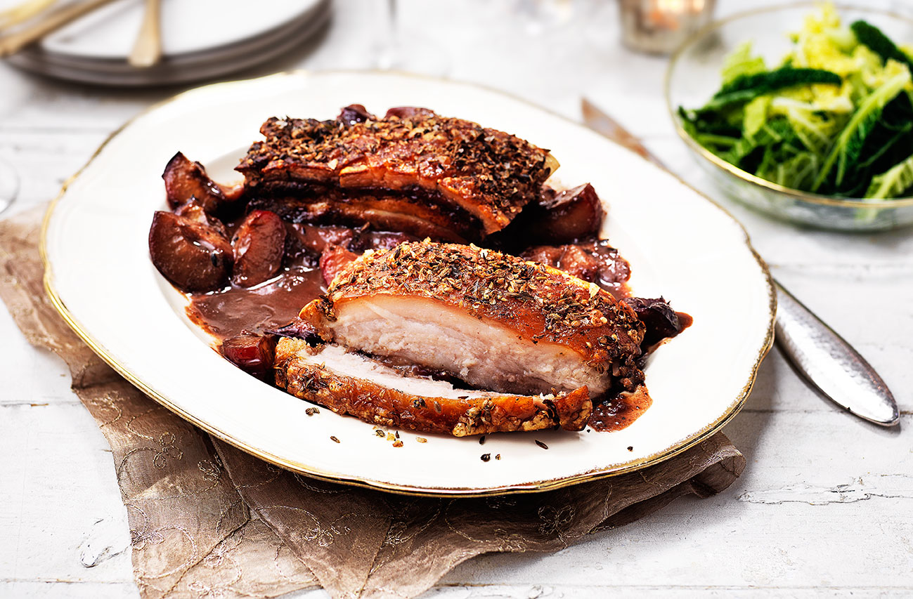 Beautifully crispy roast pork belly roasted in a coriander and fennel seed rub served with a sloe gin, plum and star anise sauce and buttered cabbage. A brilliant, alternative Christmas dinner idea that's totally worth the extra time and effort