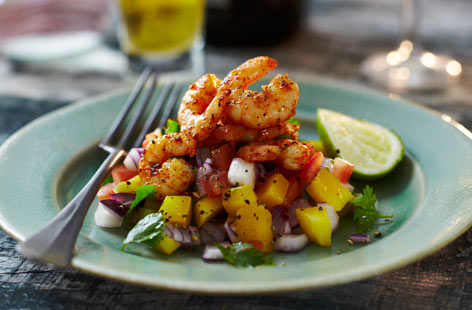 Simply dressed in a squeeze of fresh lime and smoked paprika, these grilled prawns are a great way to get a taste of Spain to your dinner table. The tart salad of mango, red onion and tomato complements the prawns excellently.