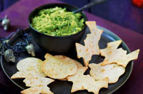 Use biscuit cutters or a sharp knife to cut out scary tortilla shapes, such as bats, pumpkins and skulls