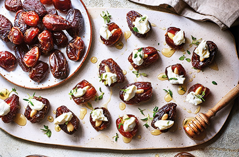 For an easy canapé recipe that's vegetarian and gluten-free, these delicious honey-drizzled dates stuffed with goat's cheese and almonds and flavoured with thyme, are a definite winner