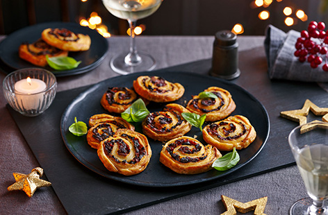 This simple Mediterranean-inspired pinwheel recipe is an easy 5-ingredient canapé. Spread olives and blitzed sundried tomatoes over puff pastry then roll and slice into delicate spirals for a vegan savoury bake - perfect made ahead of time.