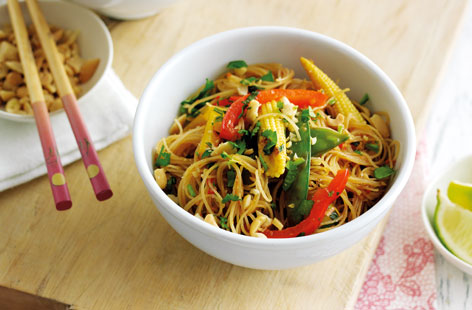 Spice up your lunch with these warm Vietnamese noodles and a garlic, lemongrass and chilli paste. To make, softened noodles, and the homemade paste and are simply stir-fried with vegetables. A meal in moments, remember to top with crunchy peanuts just before serving.