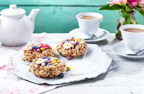 Rustle up a batch of these sweet white chocolate and coconut nests packed with pretty pastel chocolate eggs and share them with friends and family this Easter