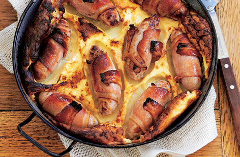 For a twist on British family favourite toad-in-the-hole, wrap good quality sausages in bacon before pouring over the batter. Here they are served with crunchy green beans in a homemade fresh tomato sauce.