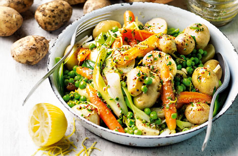 The ideal side for meat or fish combining season's best Jersey Royals with baby carrots, peas and spring onions, and a honey and lemon dressing.