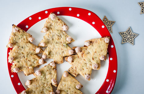 These savoury shortbread Christmas trees make for a great festive party snack. This recipe calls for a piping bag and nozzle to create the edible baubles. 