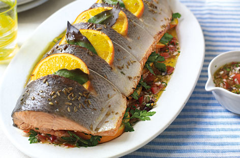 If you're looking for something impressive and substantial to serve the hungry masses, try this baked salmon with shallot vinaigrette. Before cooking, fragrant bay leaves and slices of orange are slotted into the side of fish, whilst white wine and fennel seeds are sprinkled over the top.