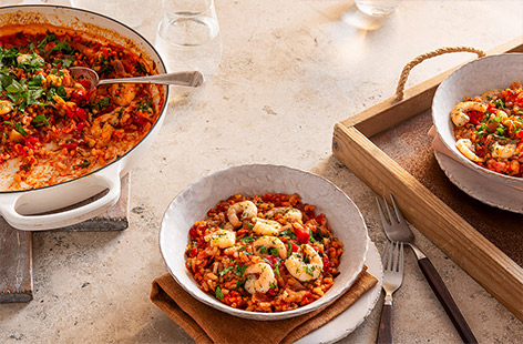 Try this twist on a risotto for an easy but impressive dinner, made with just 6-ingredients. Risotto rice is baked with juicy tinned tomatoes and plenty of fragrant marinated lemon and herb prawns for a stress-free dinner.